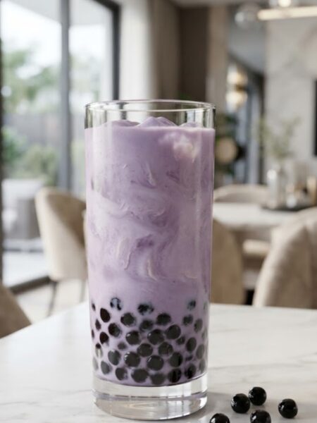 Creamy taro milk tea bubble tea with purple taro milk tea, chewy tapioca pearls, and ice