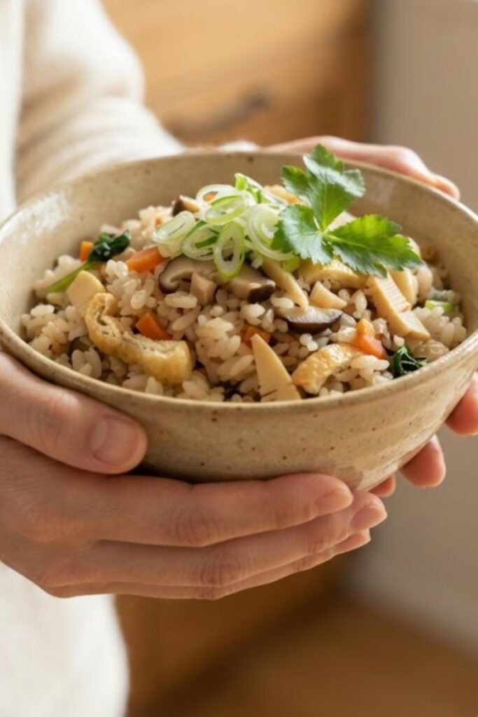 Authentic Japanese Takikomi Gohan with seasoned rice, tender chicken, shiitake mushrooms, carrots, and green onions.